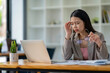 © crizzystudio - Business Woman Having Headache While Working Using Laptop Computer. Stressed And Depressed Girl Touching Her Head, Feeling Pain While Sitting At Wooden Table, Work Failure Concept