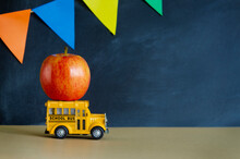 Teacher Appreciation Week School Banner. Black Schoolboard With Colorful Garland, Red Apple On Yellow Toy Bus And Place For Text. End Of School Year Or First Day Of School Concept. 