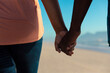 © wavebreak3 - Midsection of african american senior couple holding hands at beach