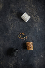 Wall Mural - skeins with threads. dark moody black with grey concrete texture or background. with place for text 