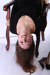 Beautiful woman upside down on a chair