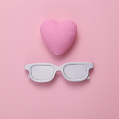 Wall Mural - Sunglasses with heart on pink background. Love concept. Top view