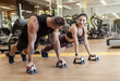 © splitov27 - Workout together. Athletic man and woman are training doing push-ups in the gym. Healthy lifestyle