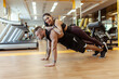© splitov27 - Strong man doing push-ups with a woman on his back in the gym
