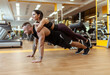 © splitov27 - Strong man doing push-ups with a woman on his back in the gym