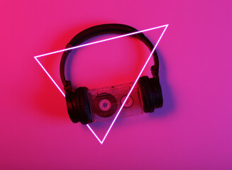  Stereo headphones with audio cassette in red blue neon light with triangle