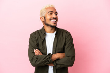 Canvas Print - Young Colombian handsome man isolated on pink background happy and smiling