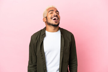 Poster - Young Colombian handsome man isolated on pink background laughing