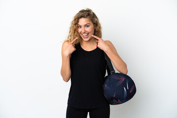 Wall Mural - Young sport woman with sport bag isolated on white background giving a thumbs up gesture