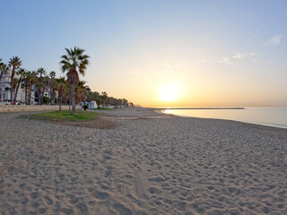 La Malagueta urban sand beach at sunset golden light on the Costa del Sol, Malaga city center, Spain, Europe