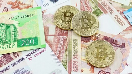 Wall Mural - Bitcoin coins (new virtual money) on Russian banknotes A close up image of bitcoins with Russian rubles banknotes Bitcoin coin on the background of Russian rubles Bitcoin Russia Ruble Cryptocurrency