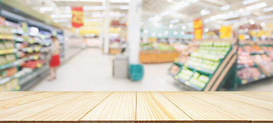 Wall Mural - Wood table top with supermarket grocery store blurred defocused background with bokeh light for product display