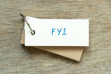 Sticker - Flash card with handwriting word FYI (Abbreviation of For your information) on wood background