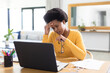 © Wavebreak Media - Tensed mid adult african american female freelancer working on laptop at desk