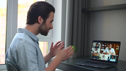 Wall Mural - Caucasian man using laptop for video connection with friends. Man talking with young people on the screen. Video chatting concept. 4K footage