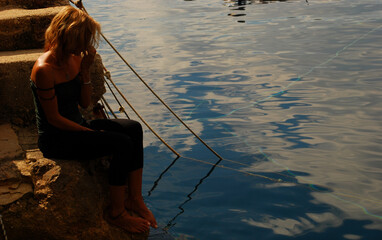 Wall Mural - the woman at dawn on the fishermen's wharf