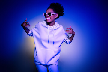 Wall Mural - Photo of cute adorable lady dressed hoodie dark eyewear having fun dancing isolated blue purple color background