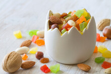 Mix Of Nuts And Candied Fruits In Eggshell Shaped Bowl On Light Background, Easter Baking Concept