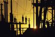 © SuperStock - Silhouette of electric power pylons