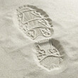 © SuperStock - Close-up of a shoe print in the sand at the beach