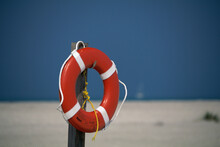 Life Preserver Hanging On A Wooden Post