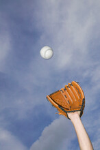 Low Angle View Of A Baseball Player Catching A Ball