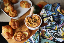 Ricotta Dip With Sun-dried Tomatoes And Baked Paprika In A Ceramic White Bowl And Homemade Popover, Which Is A Puffed, Airy, And Eggy Hollow Roll, Is Fresh From The Oven