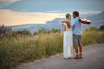 Wall Mural - Young hipster couple on road trip.wedding lovely  man and woman at nature