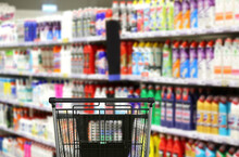Choosing Detergents, Toilet Paper In Supermarket.empty Grocery Cart In An Empty Supermarket