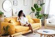 © CarlosBarquero - Cheerful Woman on a call mobile phone at home. Smiling lady is laying on the sofa.