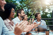 © Jadon B/peopleimages.com - Great things will continue to emerge for them. Shot of a group of colleagues applauding during a meeting at a cafe.