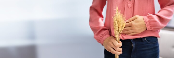 Celiac Disease And Gluten Intolerance. Women Holding Spikelet