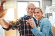 © Camerene P/peopleimages.com - Feels good to be home. Shot of a happy mature couple taking a selfie on moving day.