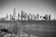 Jersey City, New Jersey, USA - December 22 2021: New York City downtown skyline. Financial district and World Trade Center. View from Statue of Liberty State Park. Black and white.