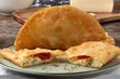 © RoYam - Brazilian pizza pastel stuffed with cheese, tomato and oregano. selective focus.