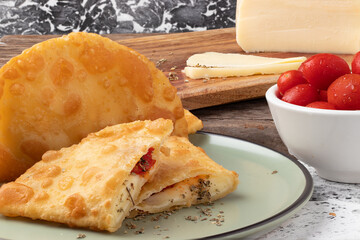 Brazilian snack pastel stuffed with cheese, tomato and oregano.