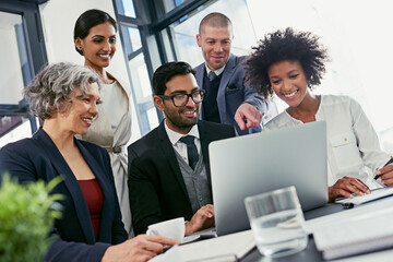 Wall Mural - motivation is best done by example and guidance. shot of a group of businesspeople coming together t