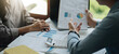 © Natee Meepian - Business people are meeting for analysis data figures to plan business strategies. Business discussing concept.
