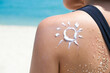 © Photo Sesaon - Hand of female holding sunscreen. Very sun light Sky background.Health concepts and skin care