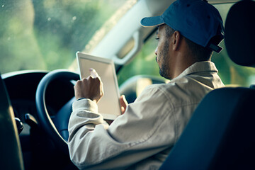 Aufkleber - Logging his next delivery. Cropped shot of a delivery man using a digital tablet while sitting in his van.
