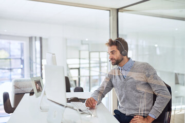 Poster - Hes on top of his work. Cropped shot of a handsome young businessman working in the office.