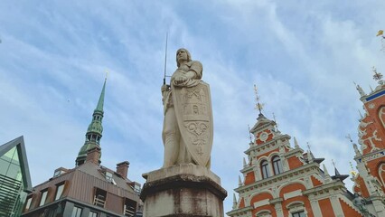 Wall Mural - Walk along the Town Hall Square in the city of Riga on a spring day. House of the Blackheads in a square with a striking facade. Roland's Skupura in the center of a stone square with paving stones