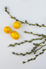 Flat lay easter composition with willow branch and gold painted eggs isolated on white background