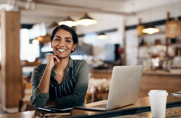 Sticker - Nothing empowers you more than owning your own small business. Shot of a young woman using a laptop while working in a cafe.