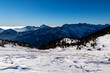 Panoramic view on snow capped mountain peaks of Karawanks in Carinthia, Austria. Julian Alps. Winter wonderland in the Austrian Alps, Europe. Ski tour, snow shoe hiking. Hochobir. Blue misty hills.