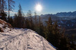 Snow covered hiking trail at early morning. Scenic view on snow capped mountain peaks of Karawanks in Carinthia, Austria. Julian Alps. Winter wonderland in Europe. Ski tour, snow shoe hiking.Hochobir