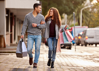 Canvas Print - Theres always time for shopping. Full length shot of an affectionate young couple enjoying a shopping spree in the city.