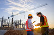 © เลิศลักษณ์ ทิพชัย - Construction engineer talks to the architect on the construction site. To describe home design work