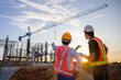© เลิศลักษณ์ ทิพชัย - A team of construction engineers talks to managers and construction workers at the construction site. Quality inspection, work plan, home and industrial building design project