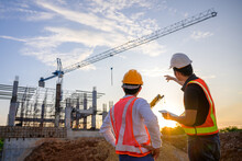 Professional Engineer Work On A Construction Site Project Work Plan For Designing Houses And Industrial Buildings Construction Site At Sunset In The Evening
